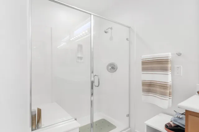 a bathroom with a shower and a sink