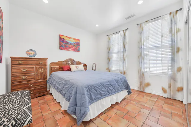 a bedroom with a bed and a dresser