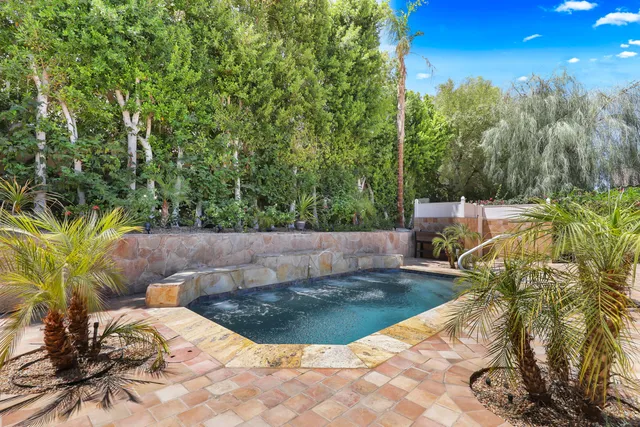 a view of a swimming pool with a patio