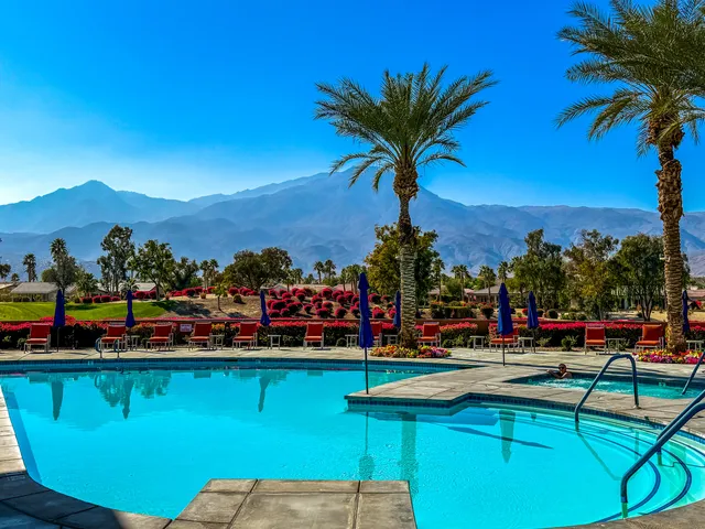 a view of a swimming pool with a table and chairs