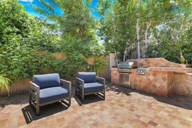 a view of a patio with chairs and a table