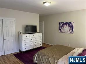 280-320 Oak Street, Unit 304D Ridgewood, NJ 07450 - Photo 12 of 23 a bedroom with a bed and a television