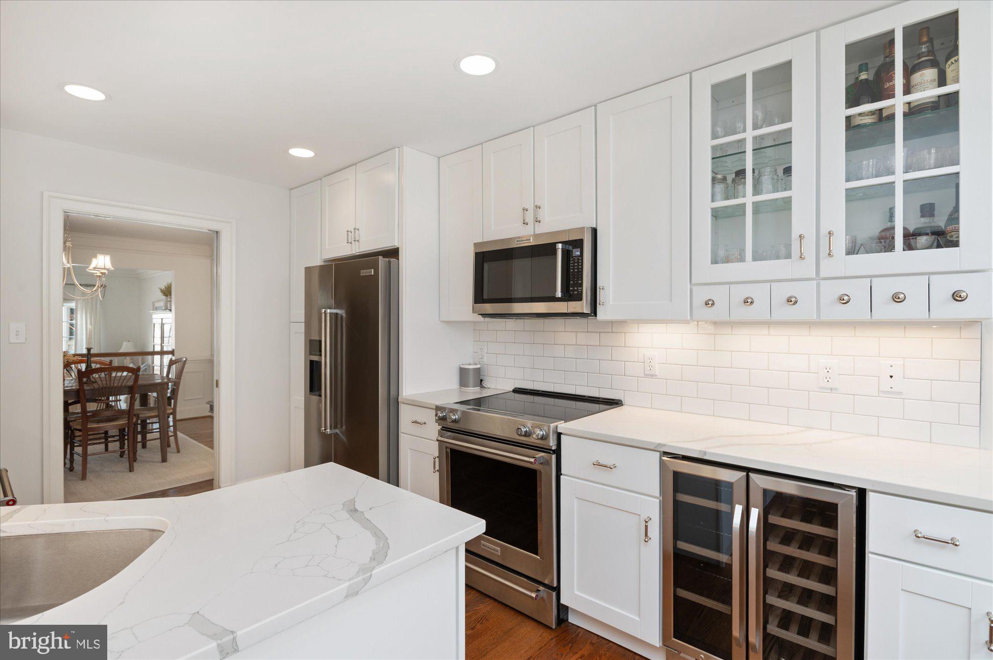 8005 Quarry Ridge Way Bethesda, MD 20817 - Photo 13 of 40 a kitchen with stainless steel appliances a stove a sink a microwave and cabinets