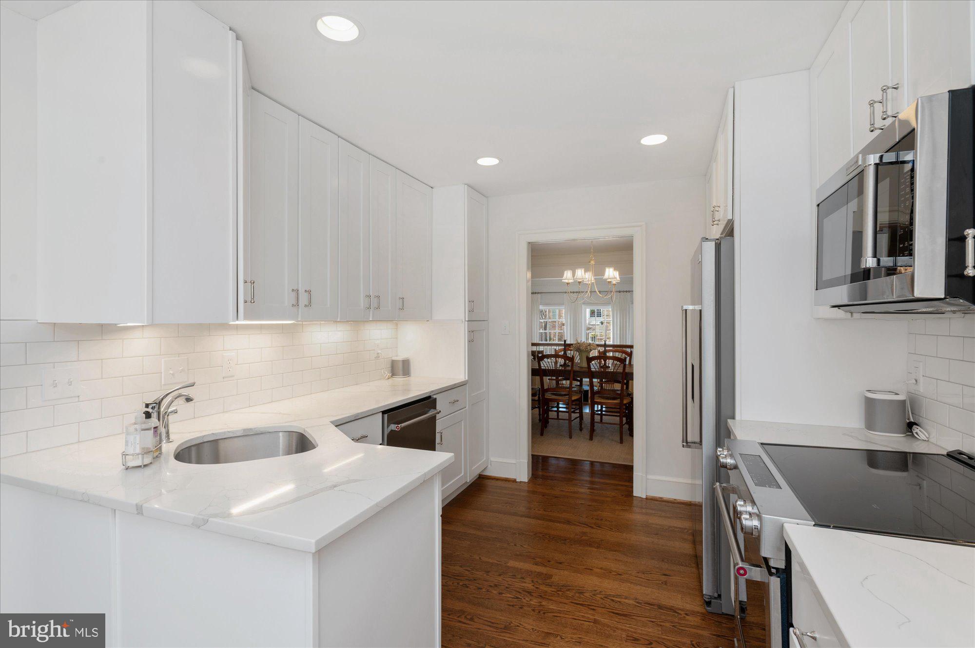8005 Quarry Ridge Way Bethesda, MD 20817 - Photo 14 of 40 a kitchen that has a sink a stove and cabinets