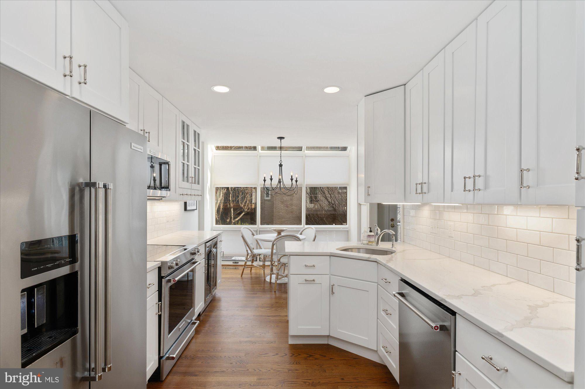 8005 Quarry Ridge Way Bethesda, MD 20817 - Photo 15 of 40 a kitchen with white cabinets and refrigerator