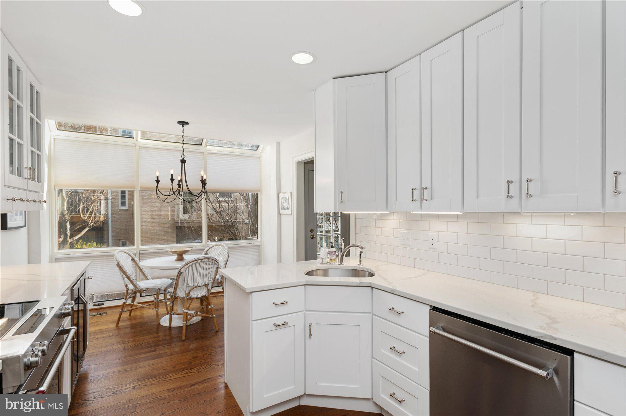 8005 Quarry Ridge Way Bethesda, MD 20817 - Photo 16 of 40 a kitchen with a sink window and chairs