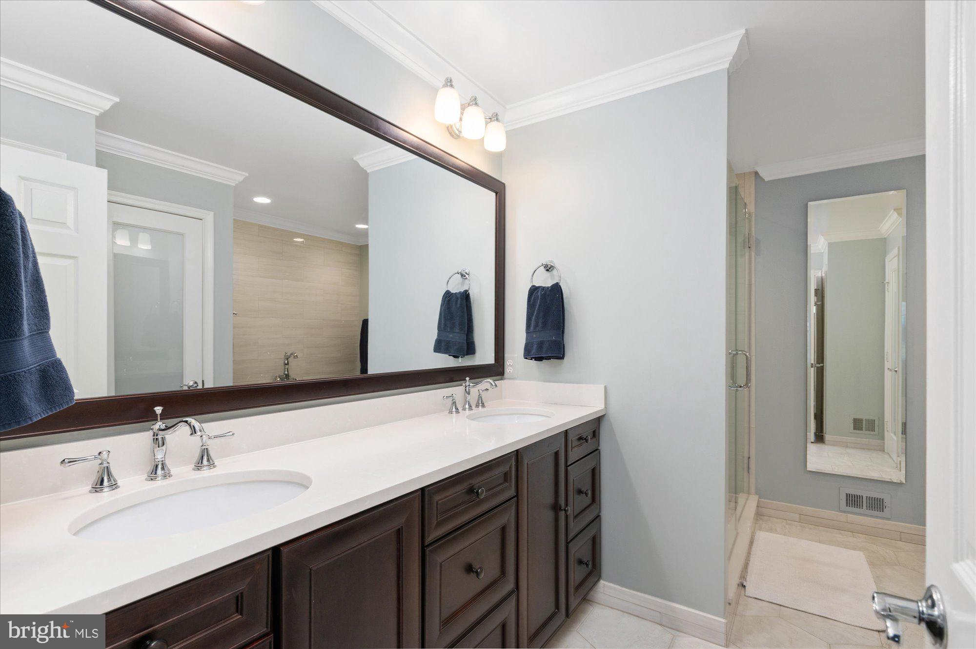 8005 Quarry Ridge Way Bethesda, MD 20817 - Photo 24 of 40 a bathroom with a sink double vanity and a mirror