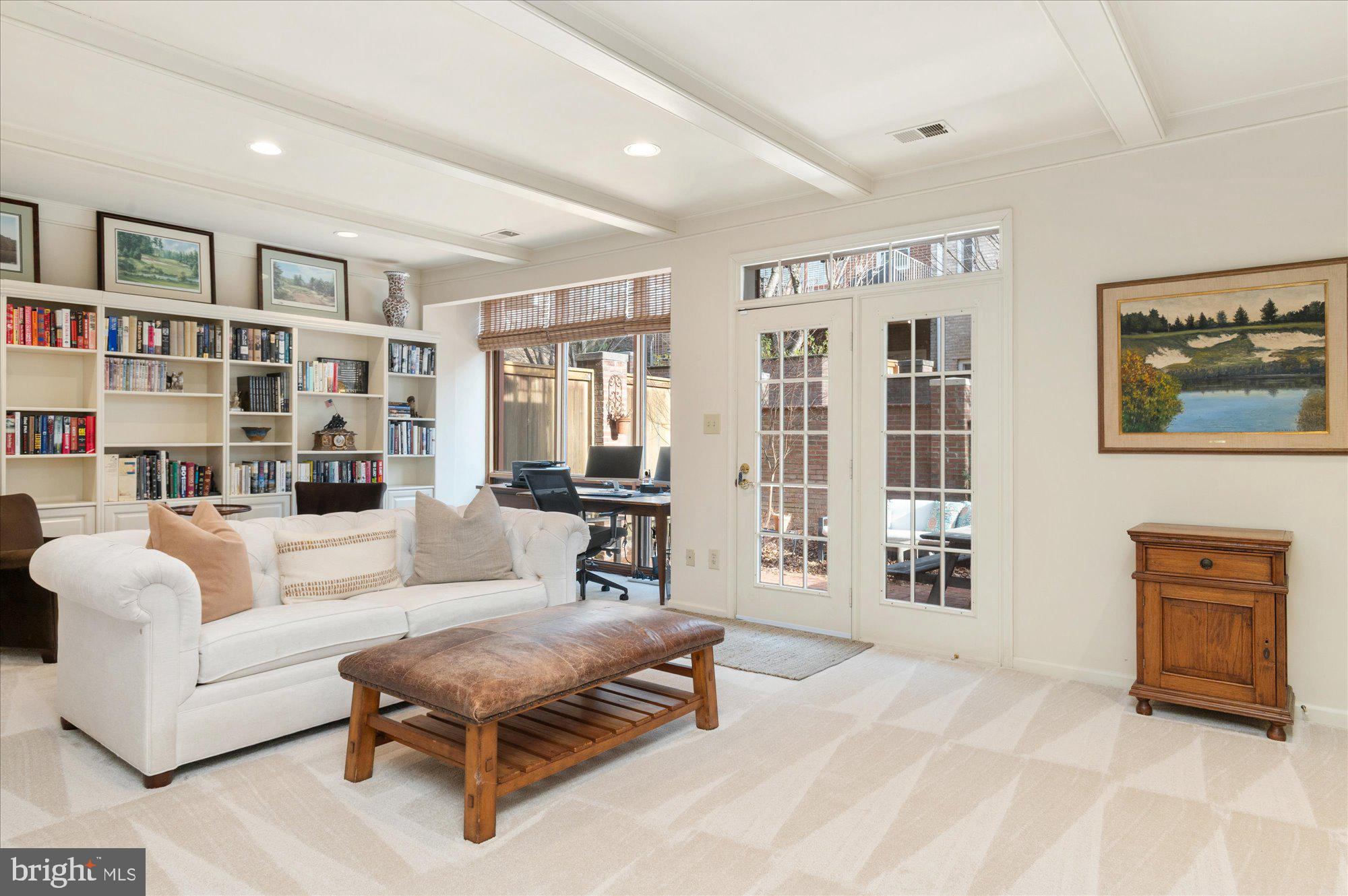 8005 Quarry Ridge Way Bethesda, MD 20817 - Photo 33 of 40 a living room with furniture and a bookshelf with wooden floor