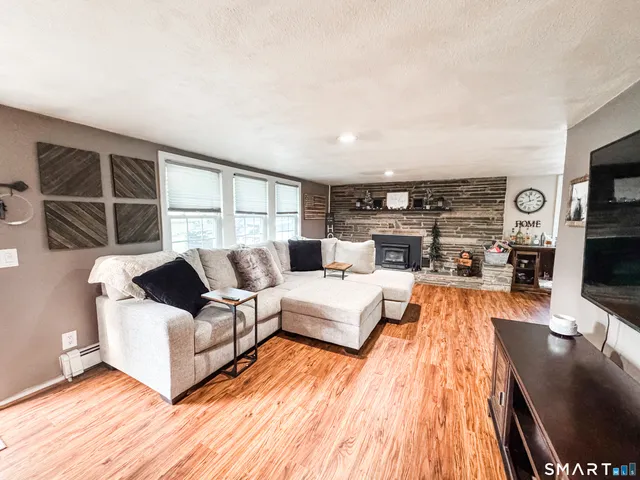 a living room with furniture fireplace and flat screen tv