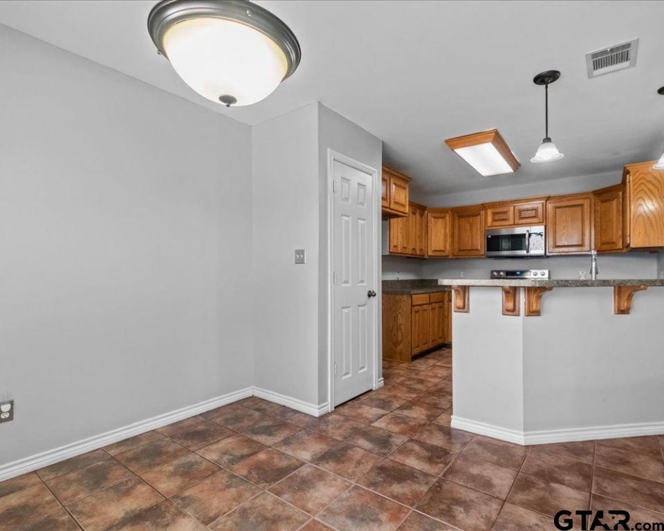 11230 Triple Crown Drive Flint, TX 75762 - Photo 11 of 19 a view of a kitchen with a sink dishwasher stove top oven and cabinets