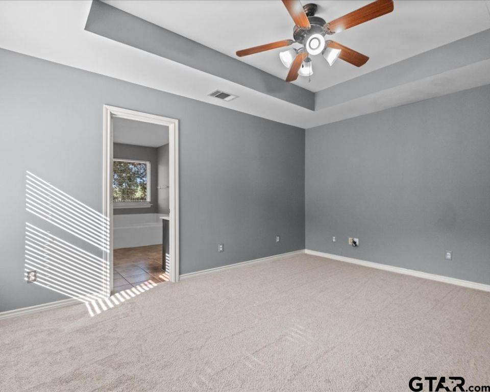 11230 Triple Crown Drive Flint, TX 75762 - Photo 14 of 19 en empty room with windows and ceiling fan