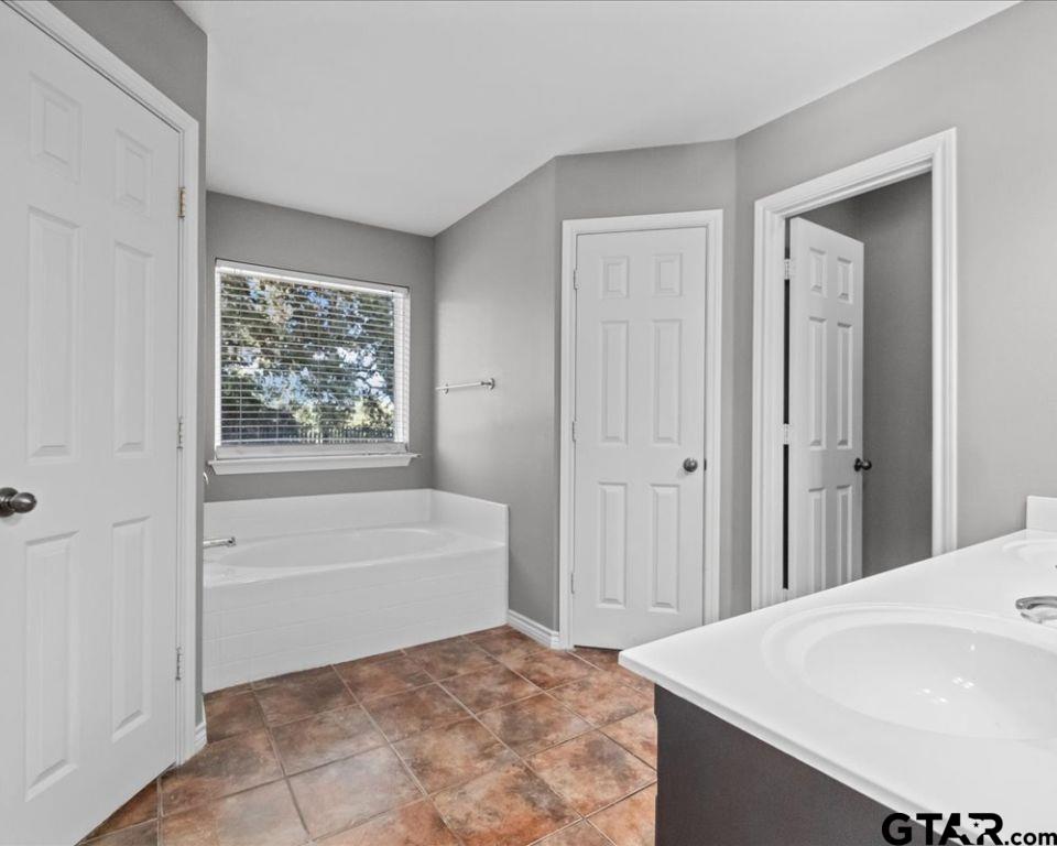 11230 Triple Crown Drive Flint, TX 75762 - Photo 16 of 19 a bathroom with a bathtub and a sink