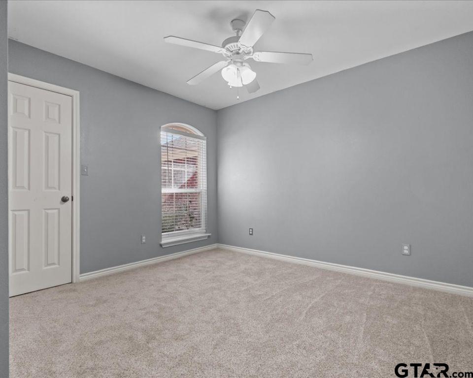 11230 Triple Crown Drive Flint, TX 75762 - Photo 17 of 19 an empty room with windows and ceiling fan