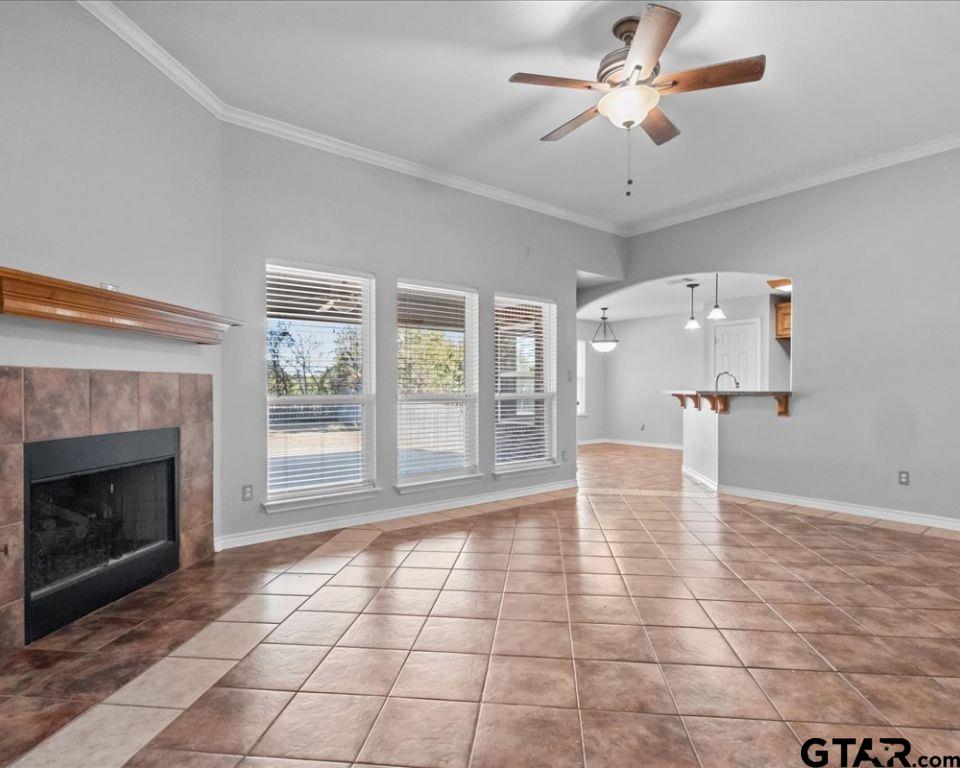 11230 Triple Crown Drive Flint, TX 75762 - Photo 6 of 19 a view of an empty room with a fireplace and a chandelier fan