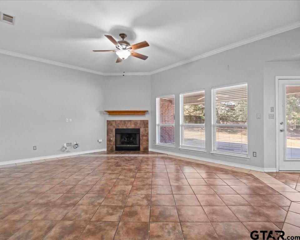 11230 Triple Crown Drive Flint, TX 75762 - Photo 7 of 19 a view of an empty room with a fireplace and a window