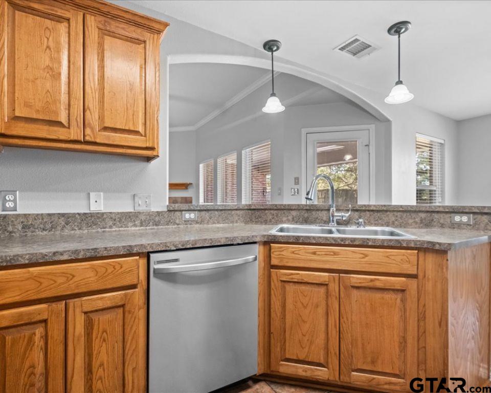 11230 Triple Crown Drive Flint, TX 75762 - Photo 10 of 19 a kitchen with kitchen island granite countertop wooden cabinets and white appliances
