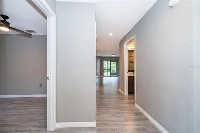a view of hallway with wooden floor