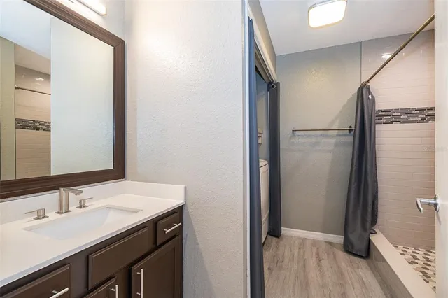 a bathroom with a sink a mirror and a shower