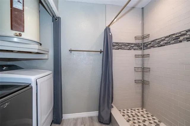 a bathroom with a shower and a sink