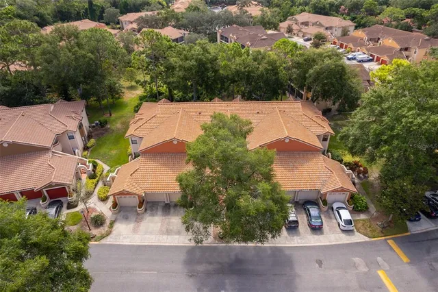 an aerial view of a house with yard