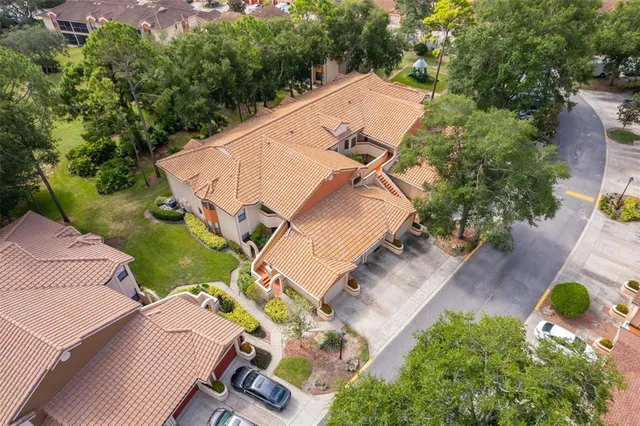 an aerial view of a house with a yard