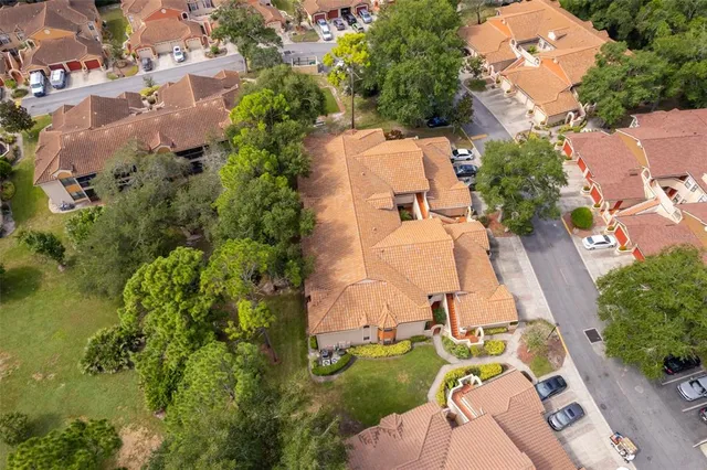 an aerial view of a house with a yard and trees