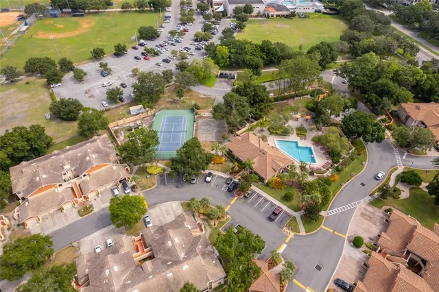 an aerial view of residential houses with outdoor space and lake view