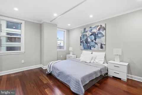 a bedroom with a large bed and a window