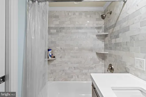 a bathroom with a bathtub and shower