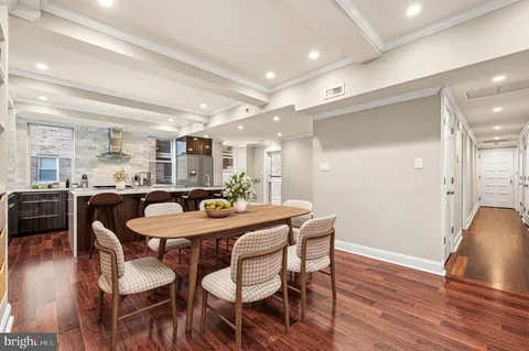 a dining room with furniture and wooden floor