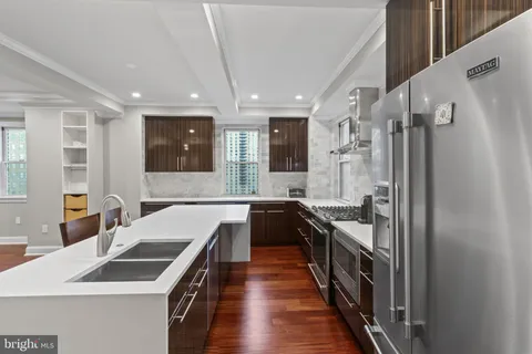 a kitchen with a sink stove and refrigerator