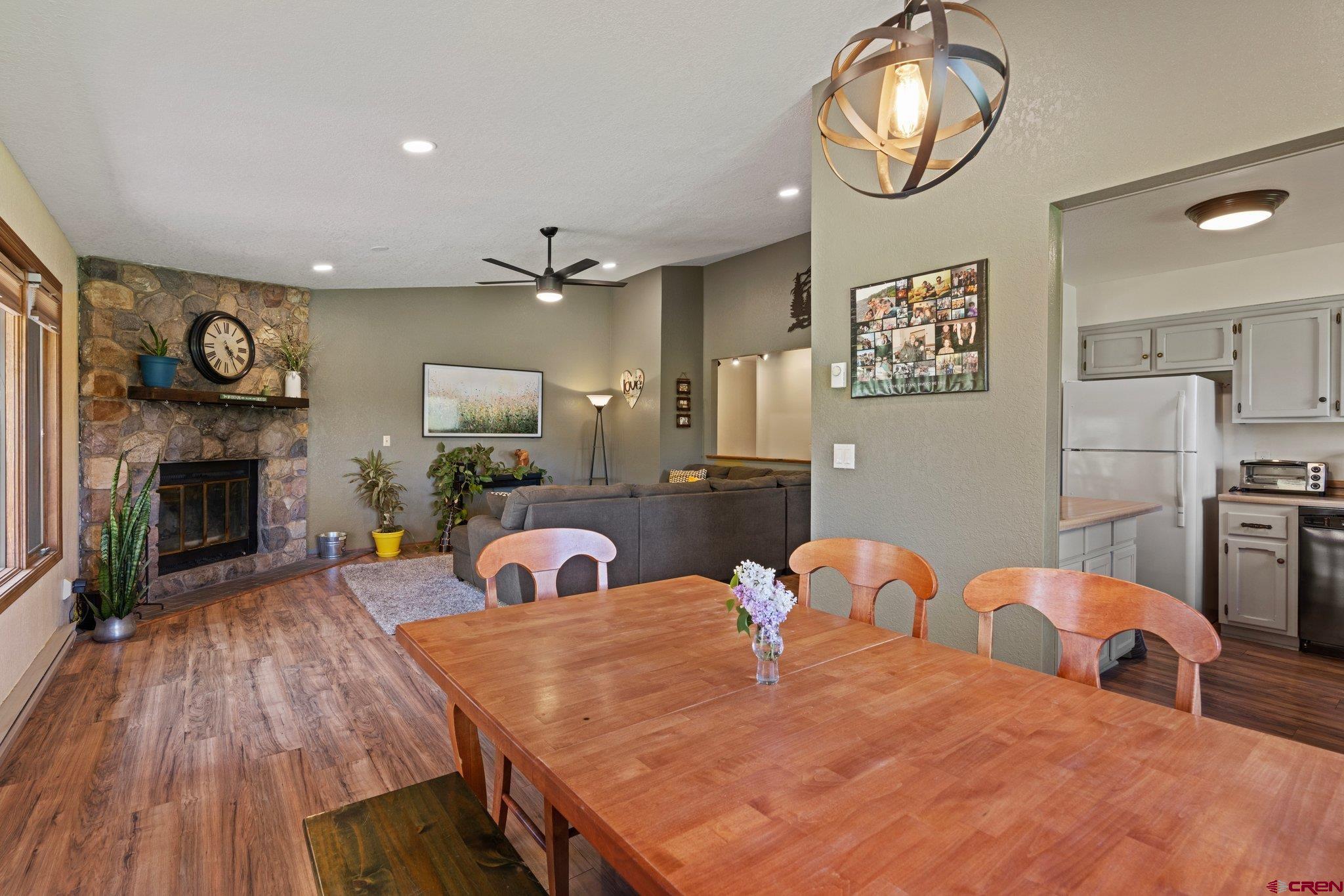 238 Pine Ridge Loop, Unit A1 Durango, CO 81301 - Photo 12 of 35 a kitchen with stainless steel appliances kitchen island granite countertop a table chairs and a refrigerator