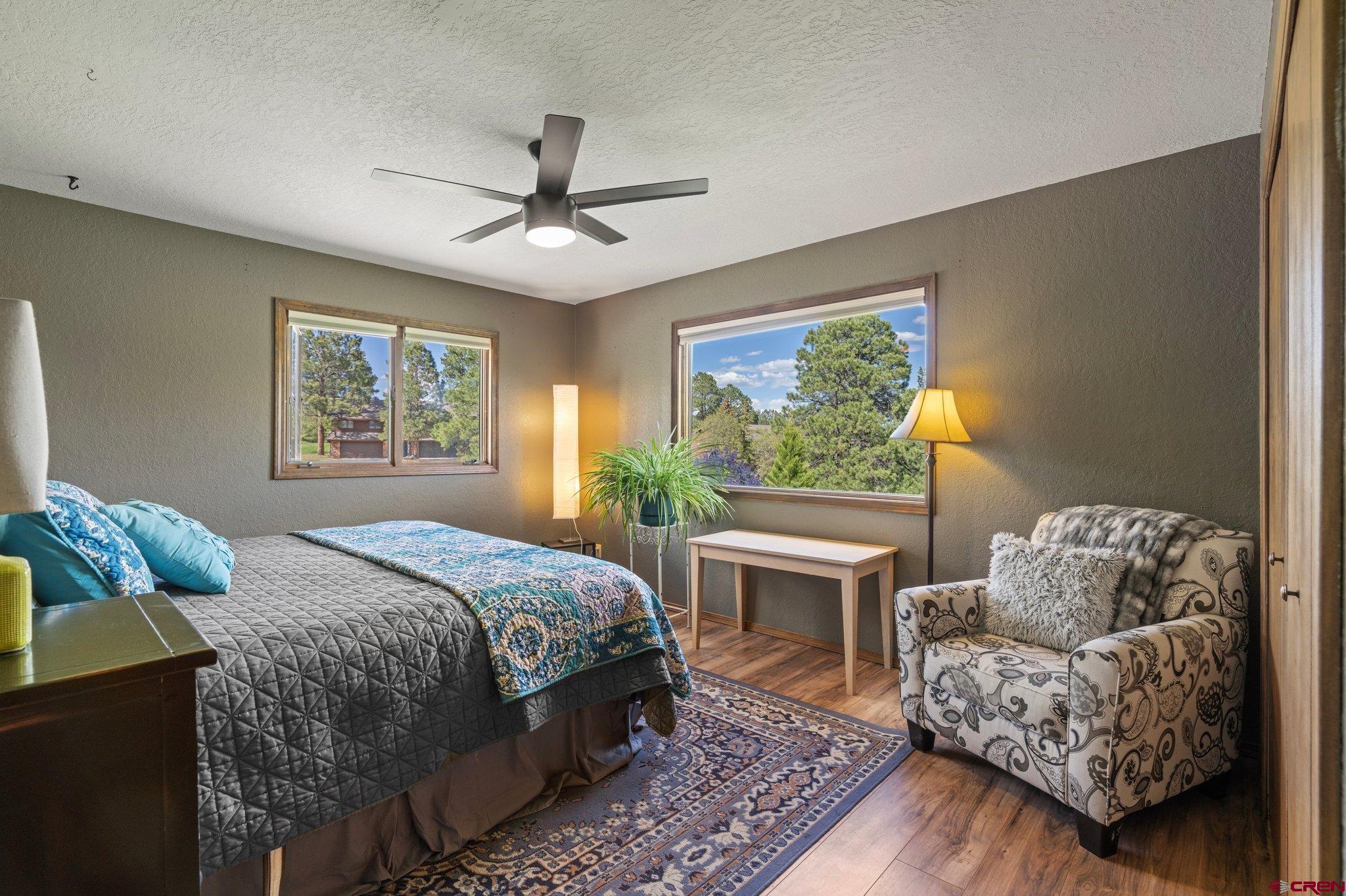238 Pine Ridge Loop, Unit A1 Durango, CO 81301 - Photo 14 of 35 a bedroom with a bed couches chair and a large window