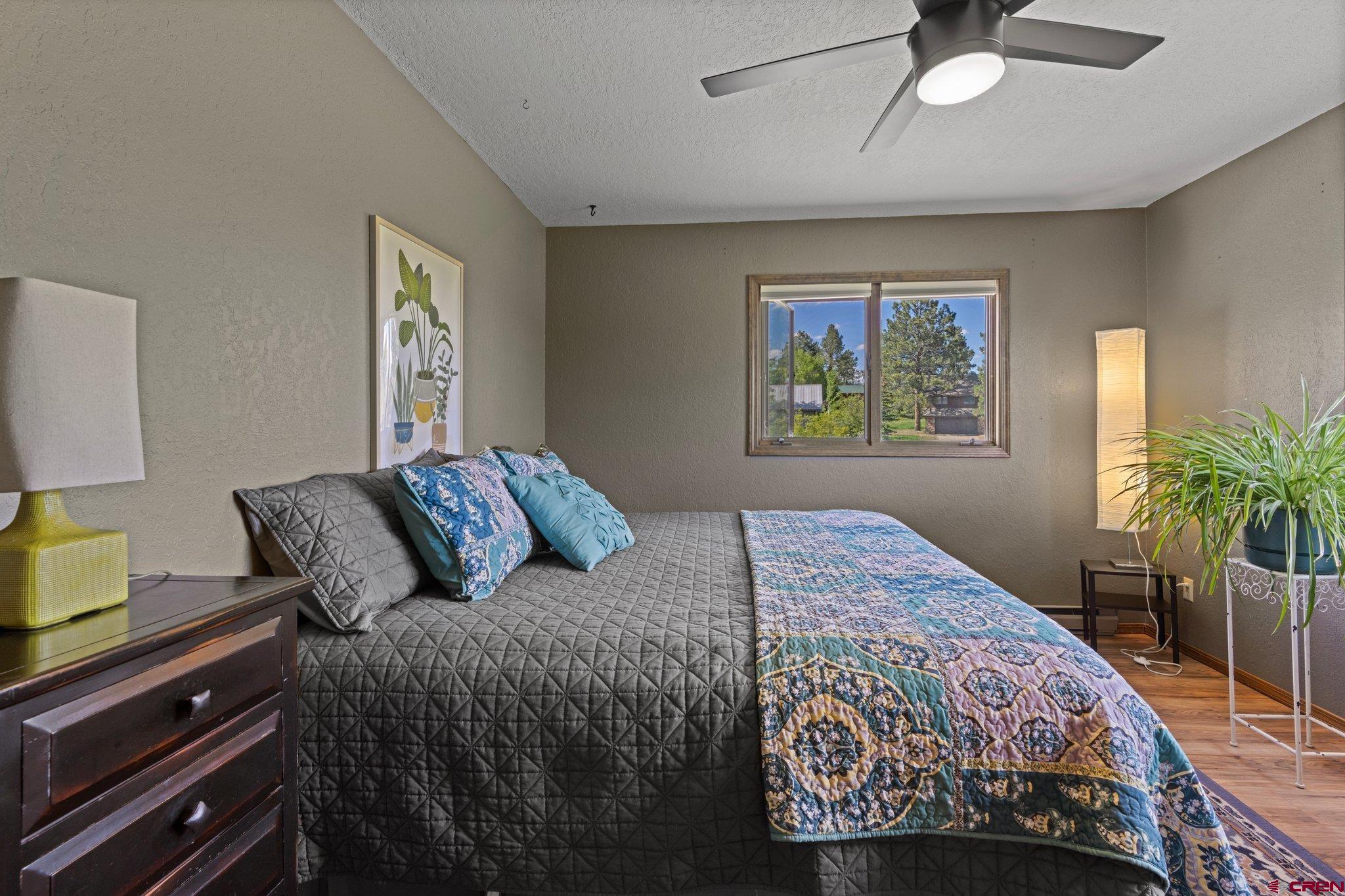 238 Pine Ridge Loop, Unit A1 Durango, CO 81301 - Photo 15 of 35 a bedroom with a bed a dresser next to a window