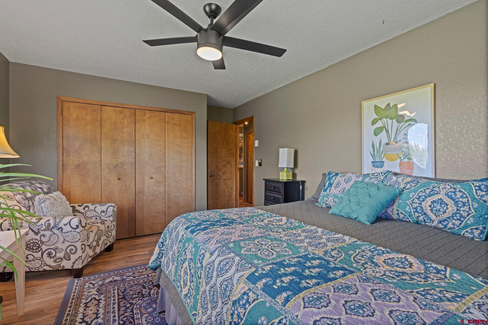 238 Pine Ridge Loop, Unit A1 Durango, CO 81301 - Photo 16 of 35 a bedroom with a large bed and a chandelier