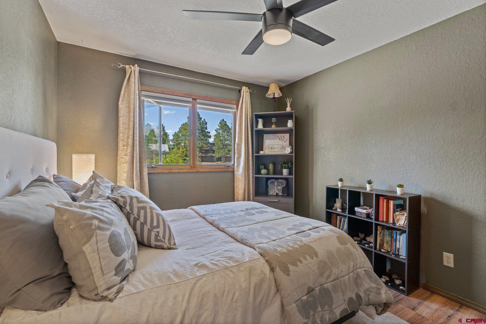 238 Pine Ridge Loop, Unit A1 Durango, CO 81301 - Photo 19 of 35 a bedroom with a large bed and a book shelf
