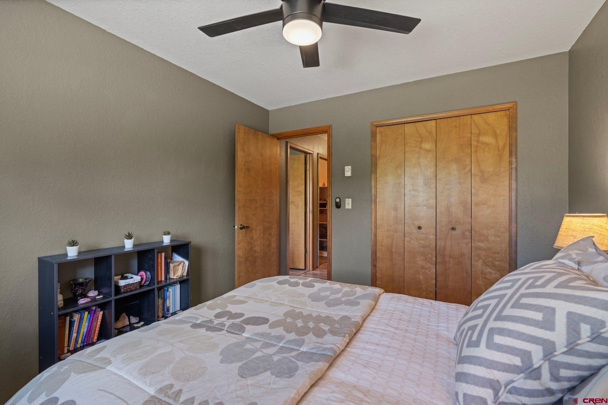238 Pine Ridge Loop, Unit A1 Durango, CO 81301 - Photo 20 of 35 a bedroom with a bed and a chandelier