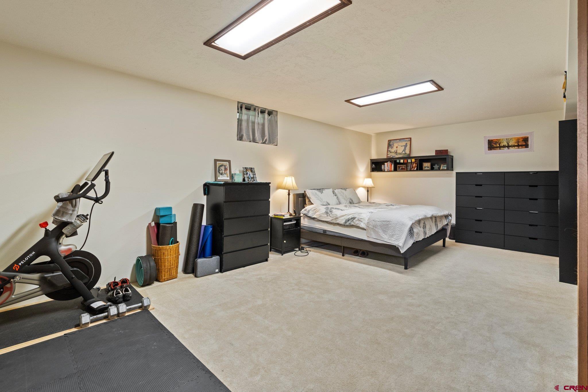 238 Pine Ridge Loop, Unit A1 Durango, CO 81301 - Photo 23 of 35 a bedroom with furniture and a gym equipment