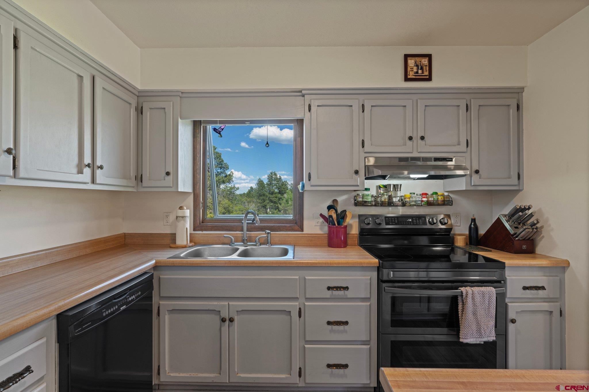 238 Pine Ridge Loop, Unit A1 Durango, CO 81301 - Photo 7 of 35 a kitchen with a sink stove and cabinets