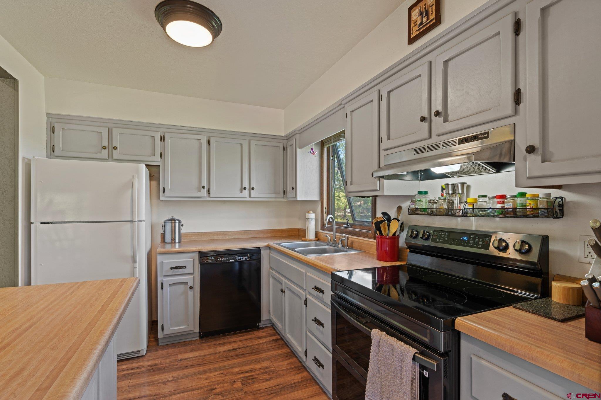 238 Pine Ridge Loop, Unit A1 Durango, CO 81301 - Photo 8 of 35 a kitchen with stainless steel appliances granite countertop a sink stove and refrigerator