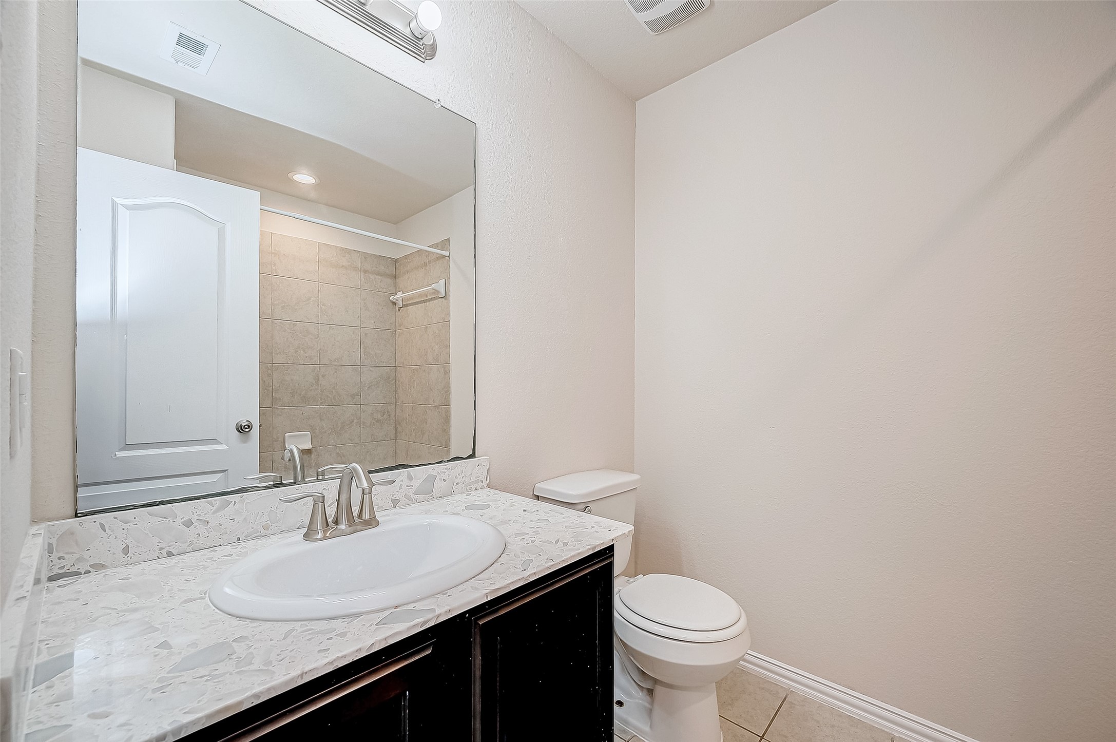 3406 Water Lilly Way Richmond, TX 77469 - Photo 34 of 44 a bathroom with a granite countertop sink a toilet and a mirror