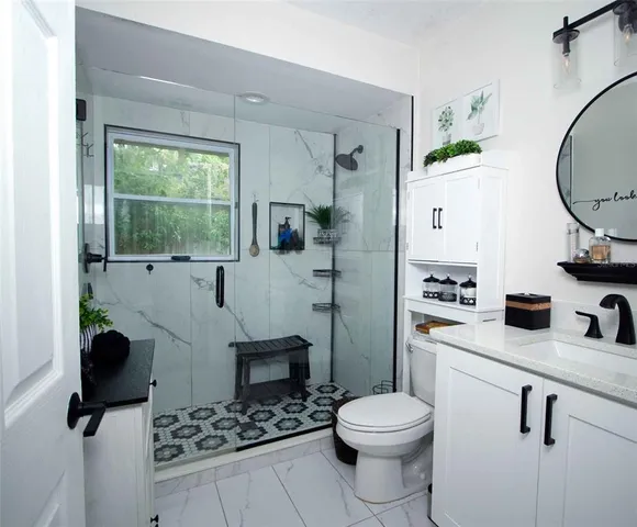 a bathroom with a toilet a sink and a mirror