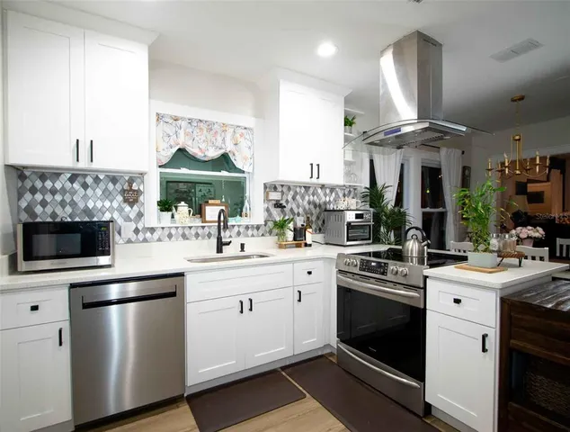 a kitchen with a sink stove and cabinets
