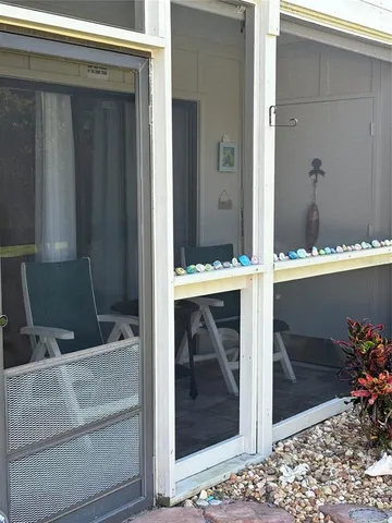 a view of a swimming pool with a yard and sitting area
