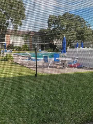 a view of a patio with swimming pool table and chairs