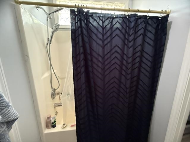 395 Austin Street Savannah, TN 38372 - Photo 14 of 32 Shower-over-tub combination with a wall-mounted shower head and a handheld shower head
