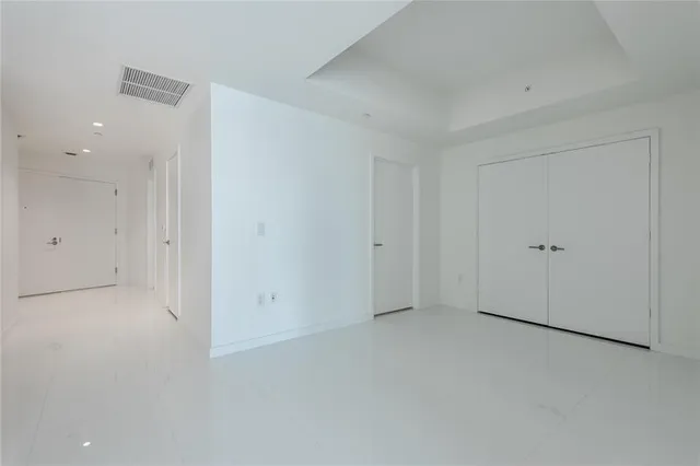 a view of a hallway with wooden shelves