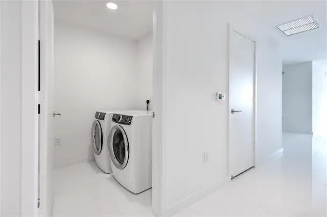 a bedroom with furniture and a large window