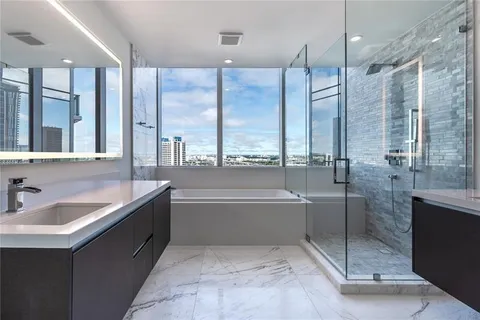 a bathroom with a double vanity sink toilet and a bathtub