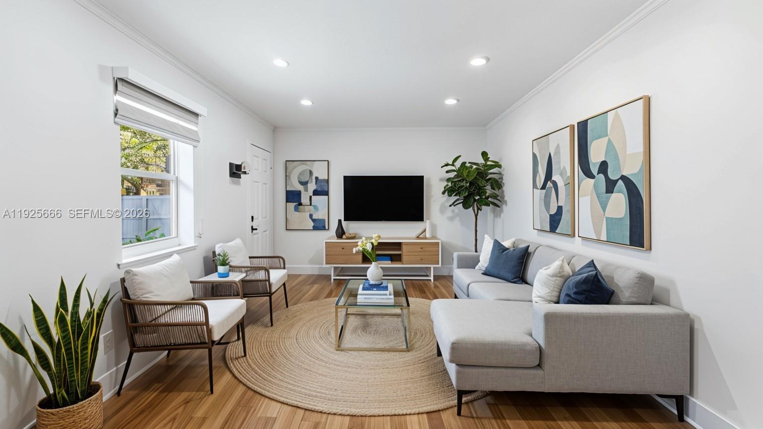 a living room with furniture and a flat screen tv